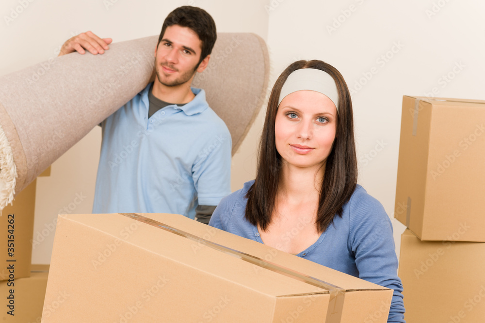 Home moving young couple boxes and carpet Home moving young couple boxes and carpet