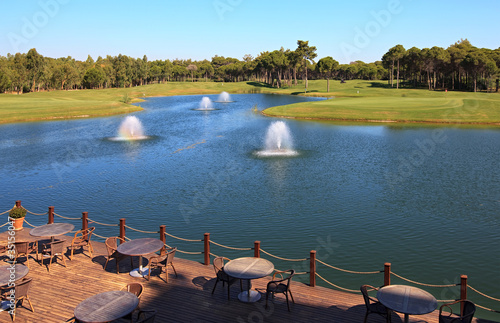 Cafe on the artificial pond with fountain.