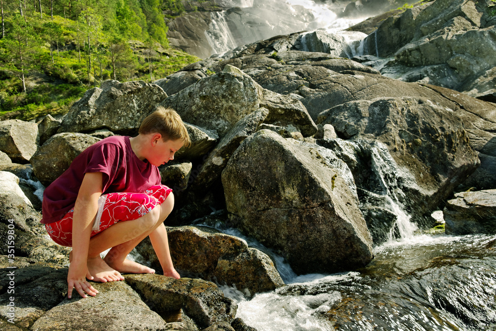 Boy at the waterfall.