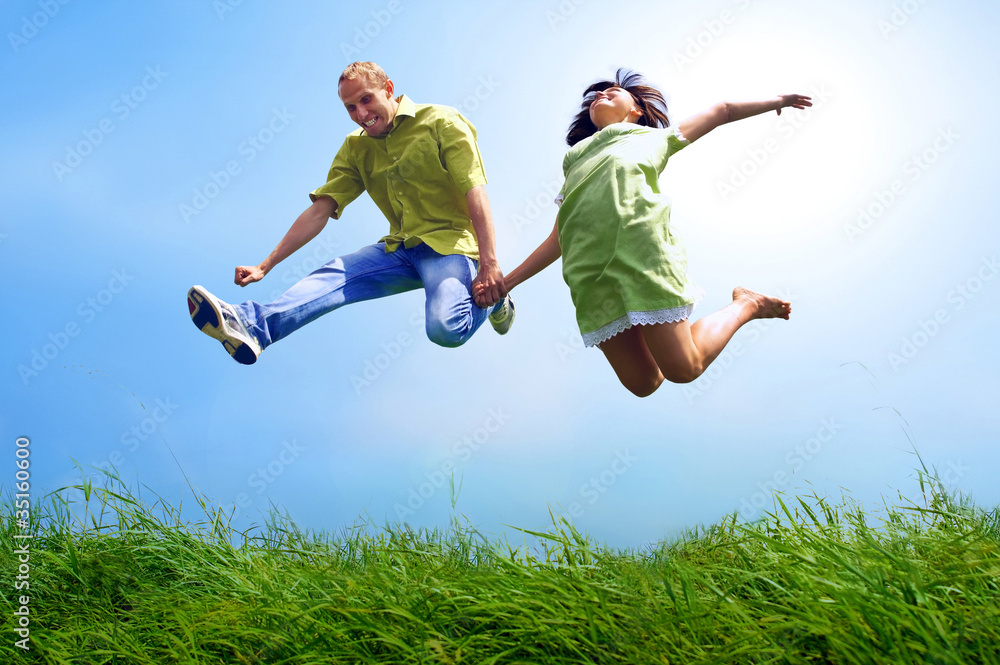 Fun couple in jump on the outdoor background Fun couple in jump on the outdoor background