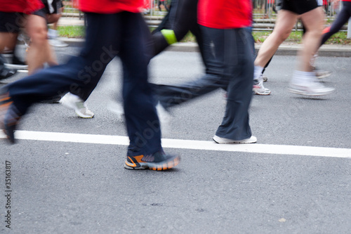 People running in city marathon on a street