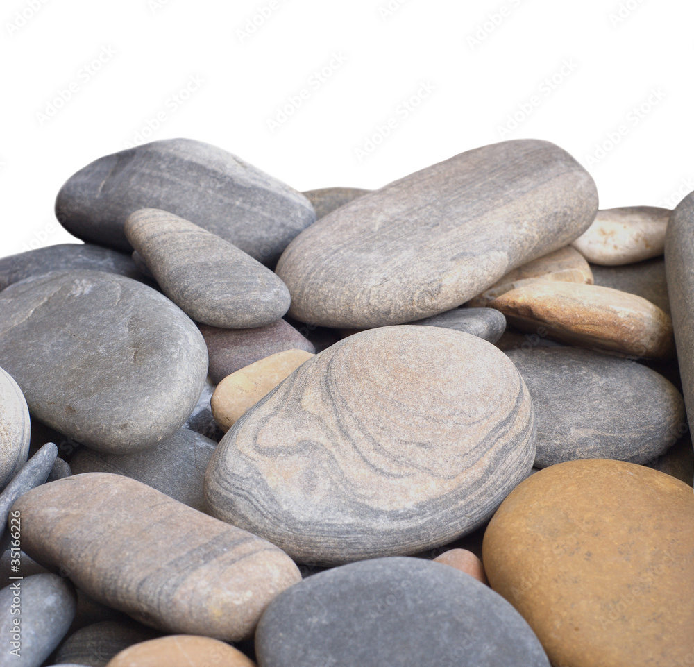 Many smooth sea stones isolated on white closeup Many smooth sea stones isolated on white closeup