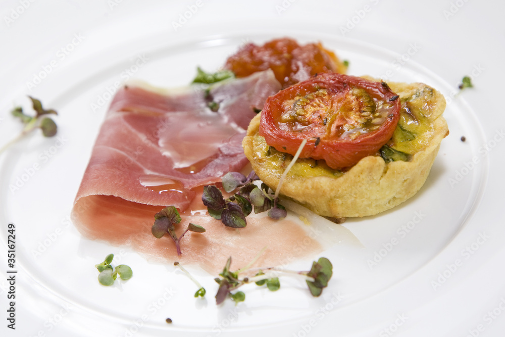 Breakfast quiche, topped with grilled tomato and parma ham. Breakfast quiche, topped with grilled tomato and parma ham.