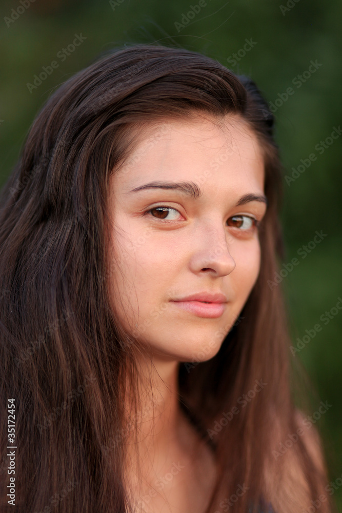 portrait of pretty beautiful young girl in the evening sunshine