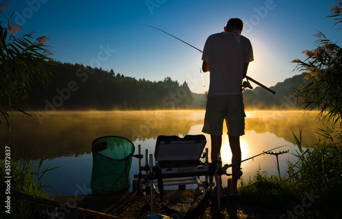 Fotografia, Obraz Silhouette of Man Fishing at Sunrise