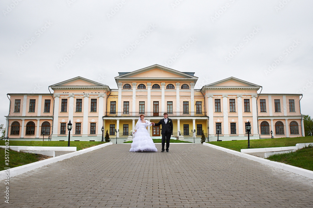 Bride and groom at wedding  walk near palace