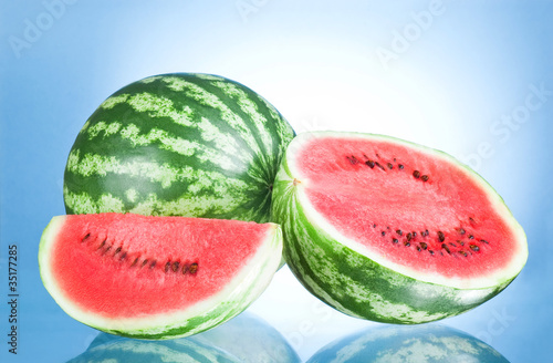 Whole watermelon, half and Slice on a blue background