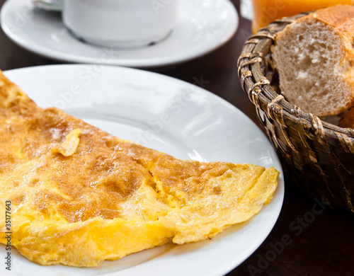 omelet with ham and coffee on table