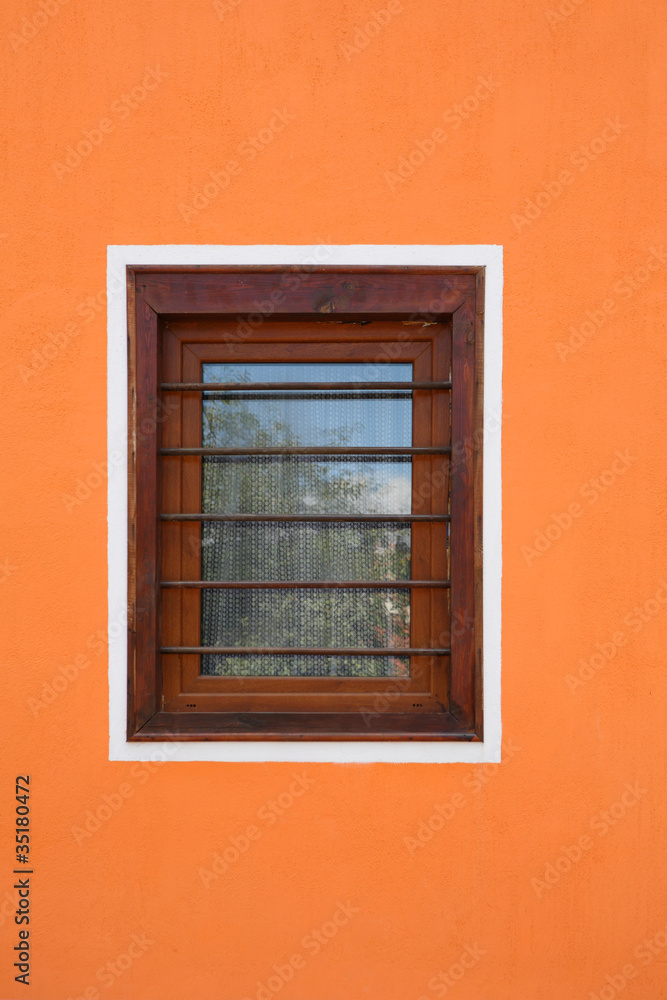 wooden window on orange cement wall