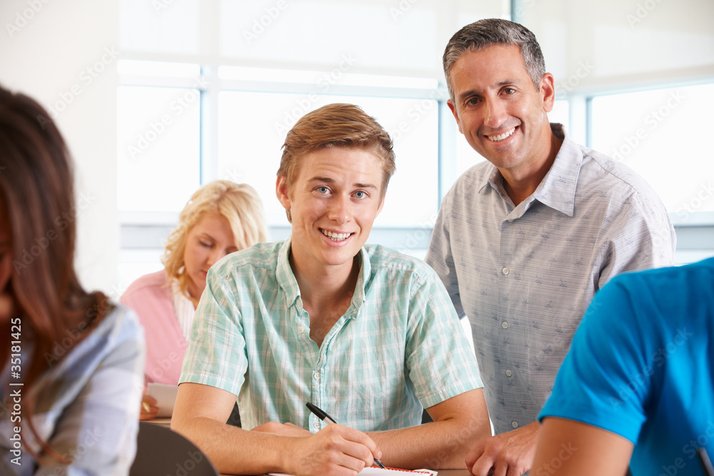Tutor helping student in class Tutor helping student in class