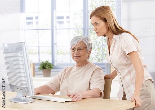 Senior mother and daughter using computer
