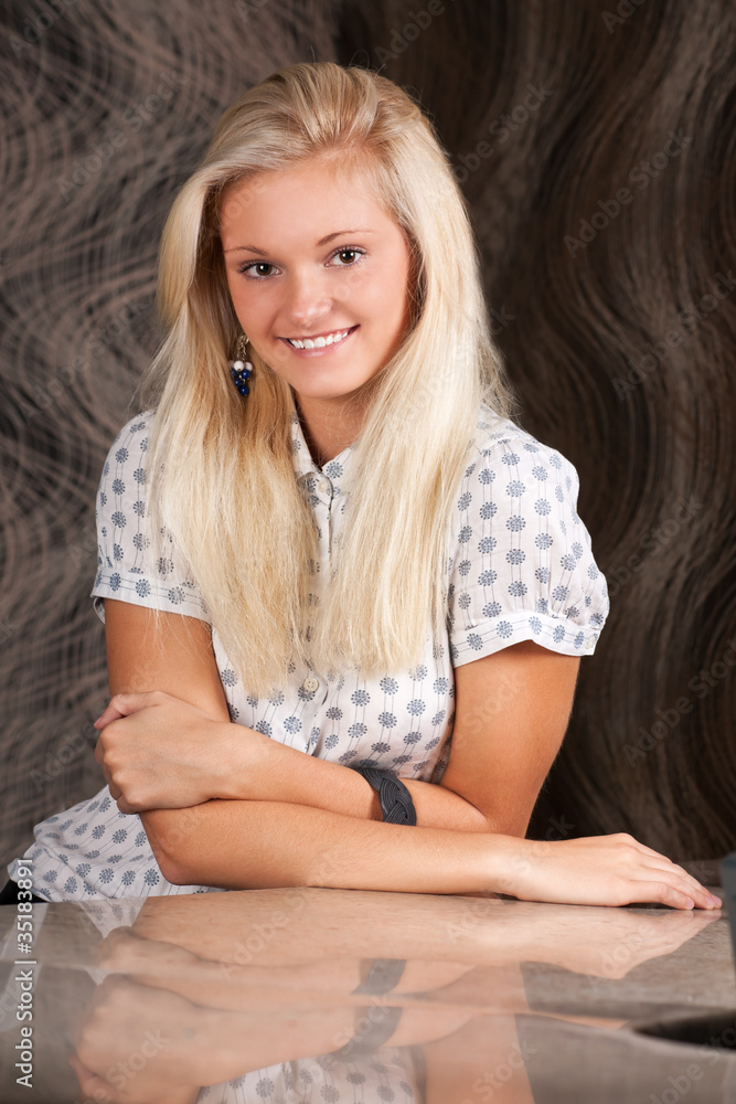Fototapeta premium Smiling blond girl in white shirt
