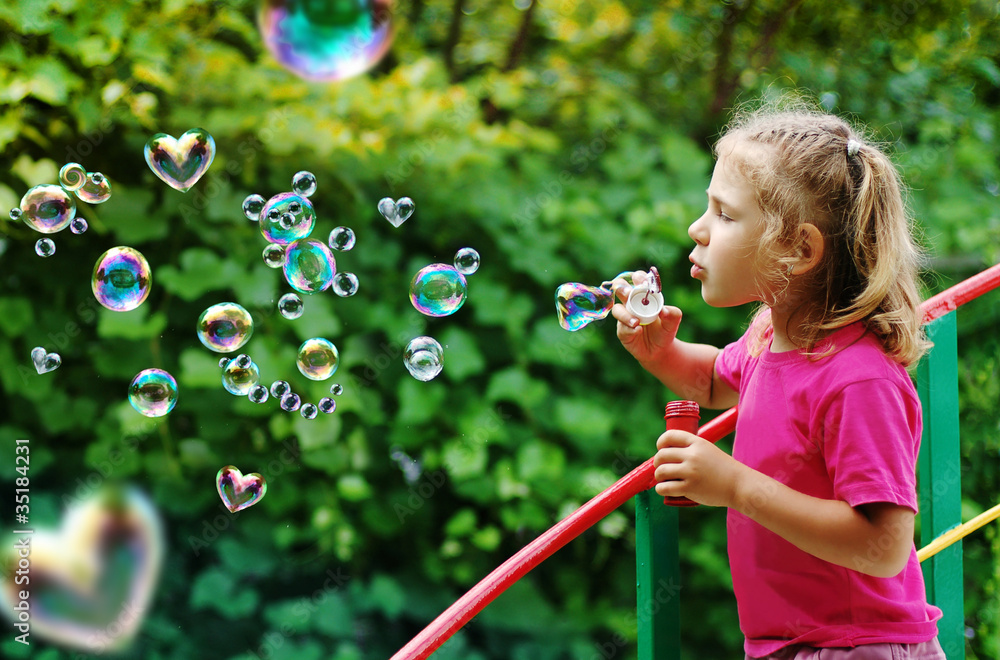 Little girl blowing interesting bubbles Little girl blowing interesting bubbles