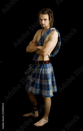 Young man dressed in a scottish kilt
