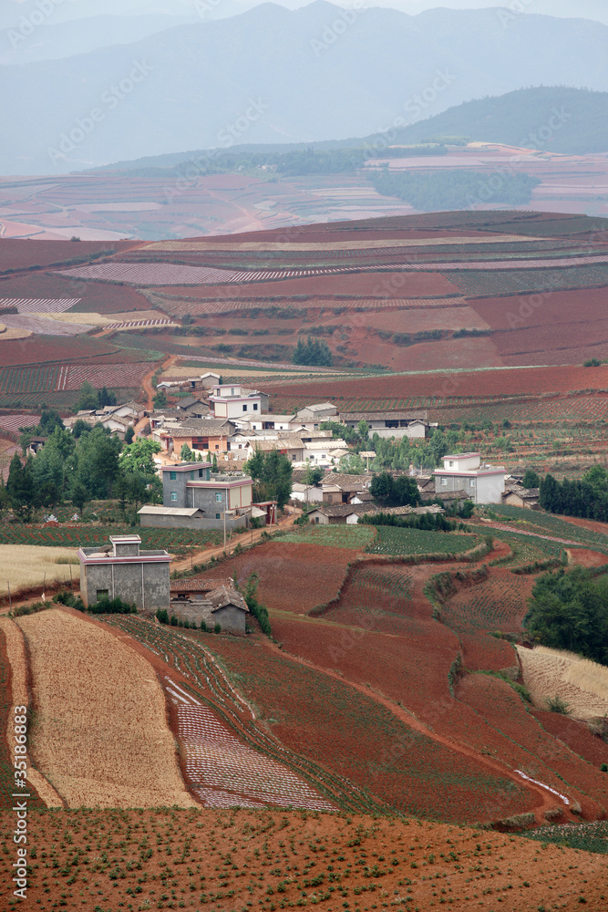 colorful farmland with village in dongchuan of china