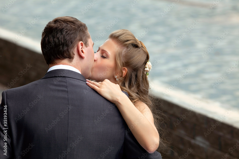 young wedding couple kissing