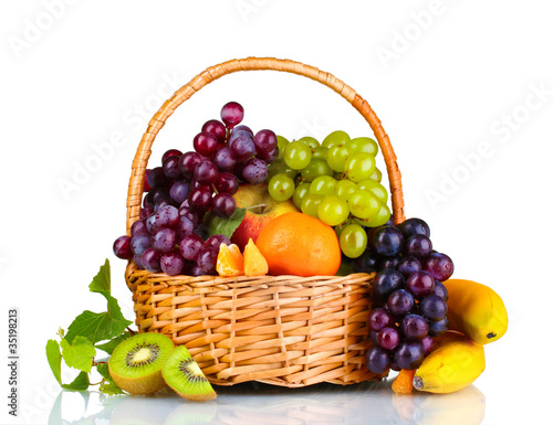 Ripe juicy fruits in  basket isolated on white