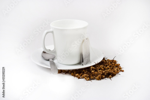 White Tea Cup, Tea Bag and Loose Herbal Tea on White Background