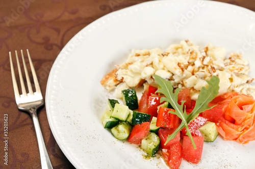 Scrambled eggs with salmon and vegetables