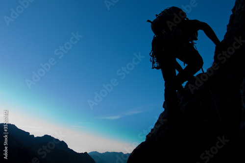Silhouette of a climber with large copay space