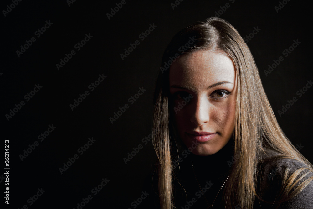 Affascinante bionda su sfondo nero che guarda dritto Affascinante bionda su sfondo nero che guarda dritto