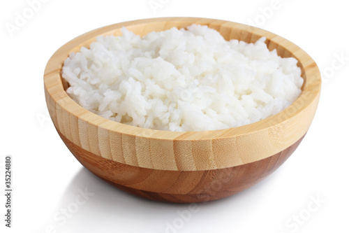 Wooden bowl of cooked rice isolated on white