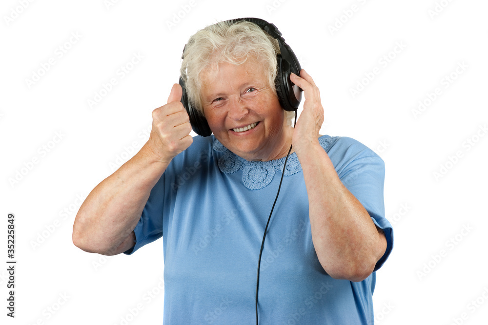 Senior woman with eraphones is making OK gesture Senior woman with eraphones is making OK gesture