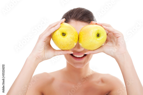 woman holding apples over her eyes