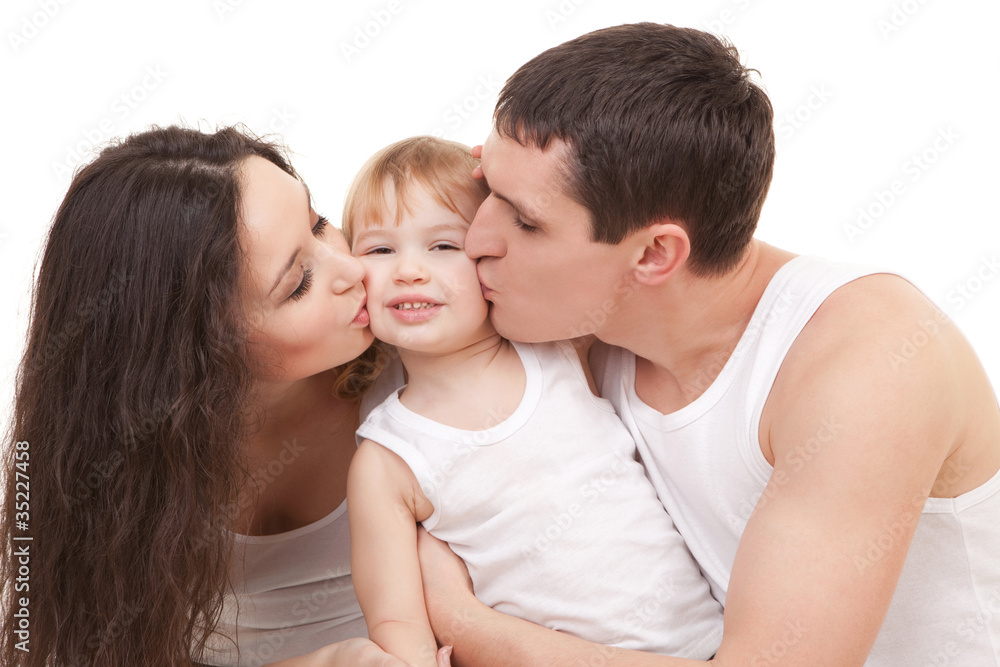 Happy family, mother, father and daughter on the white bed Happy family, mother, father and daughter on the white bed