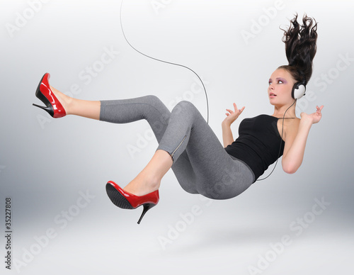 Young girl with headphones in unreal pose