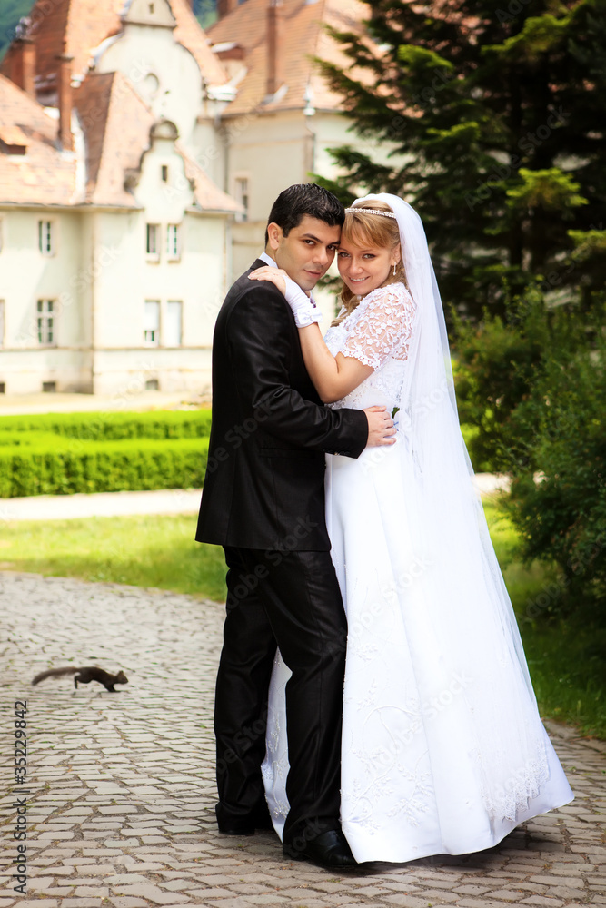 young wedding couple outdoors on their wedding day young wedding couple outdoors on their wedding day