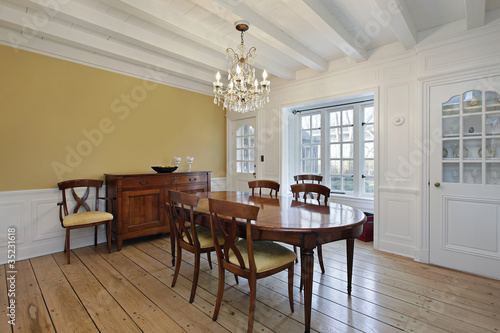 Dining room with white wood ceiling beams
