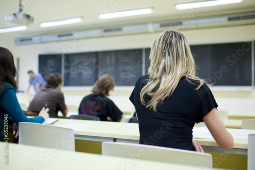 young, pretty female college student sitting in a classroom