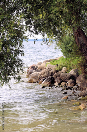 Rocky lake shore with lush foliage