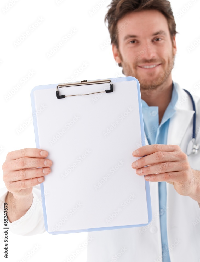 Handsome doctor holding blank sheet smiling Handsome doctor holding blank sheet smiling