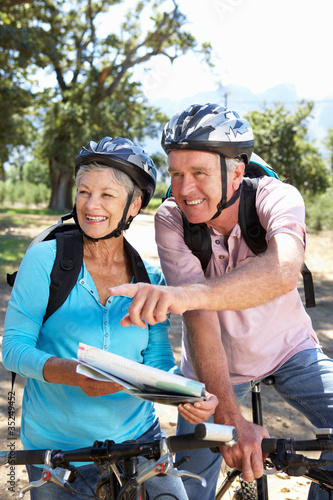 Senior couple with map on country bike ride