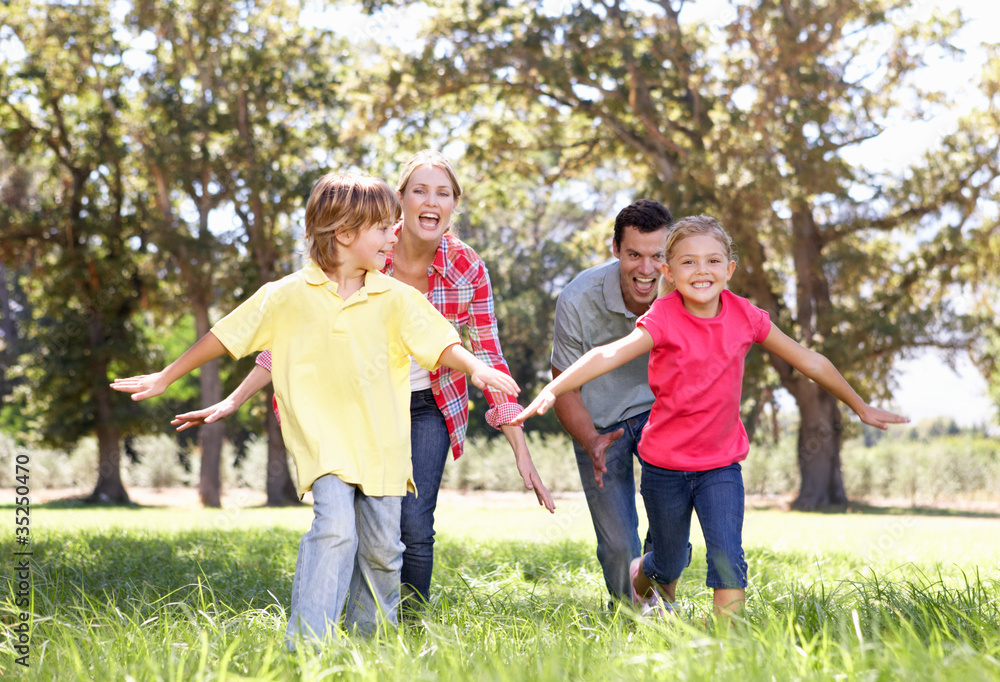 Fototapeta premium Parents playing with children in country