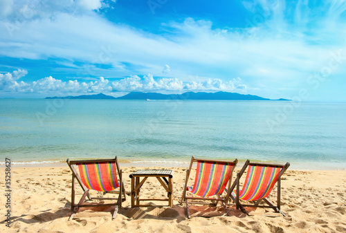 Chairs on beach near with sea © Andrii Vergeles