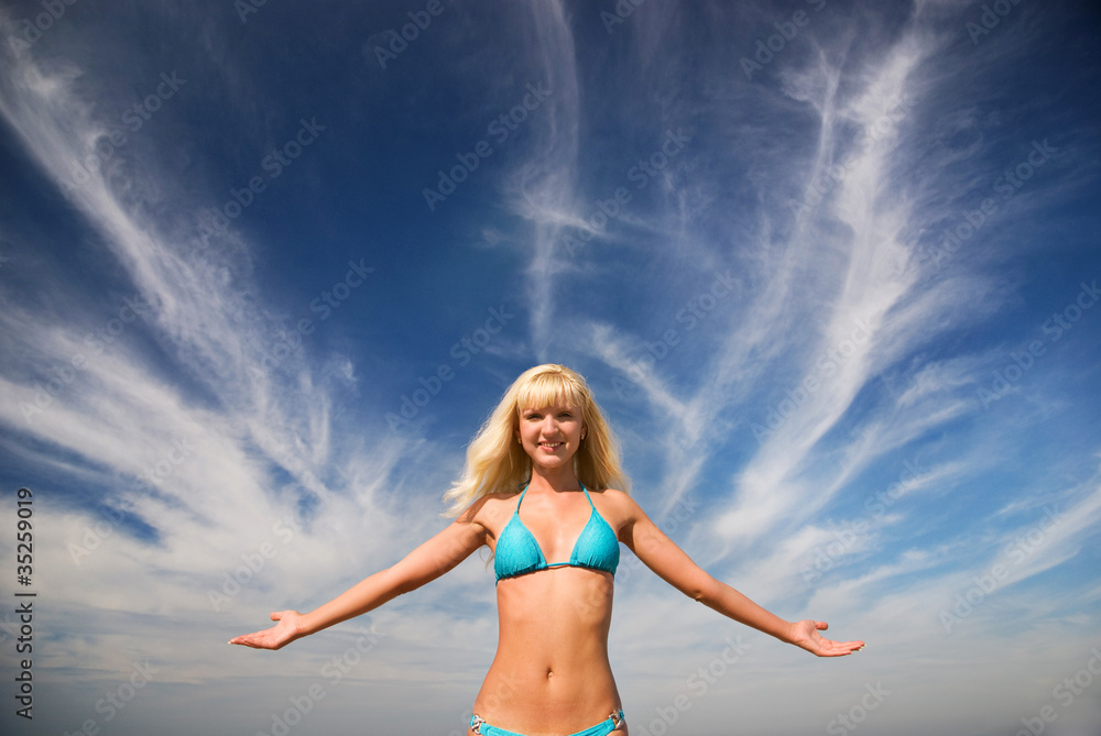 Happy blond beautiful smiling girl and the blue bright sea