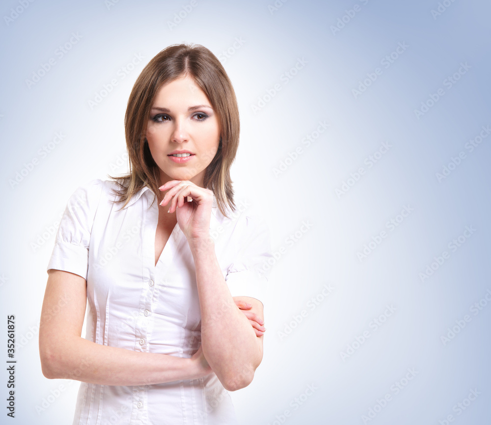 Young attractive brunette isolated over blue background Young attractive brunette isolated over blue background