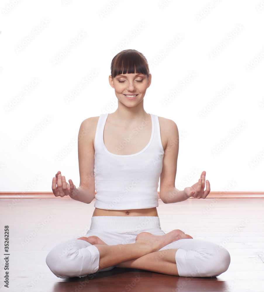 A young and fit meditating Caucasian brunette woman