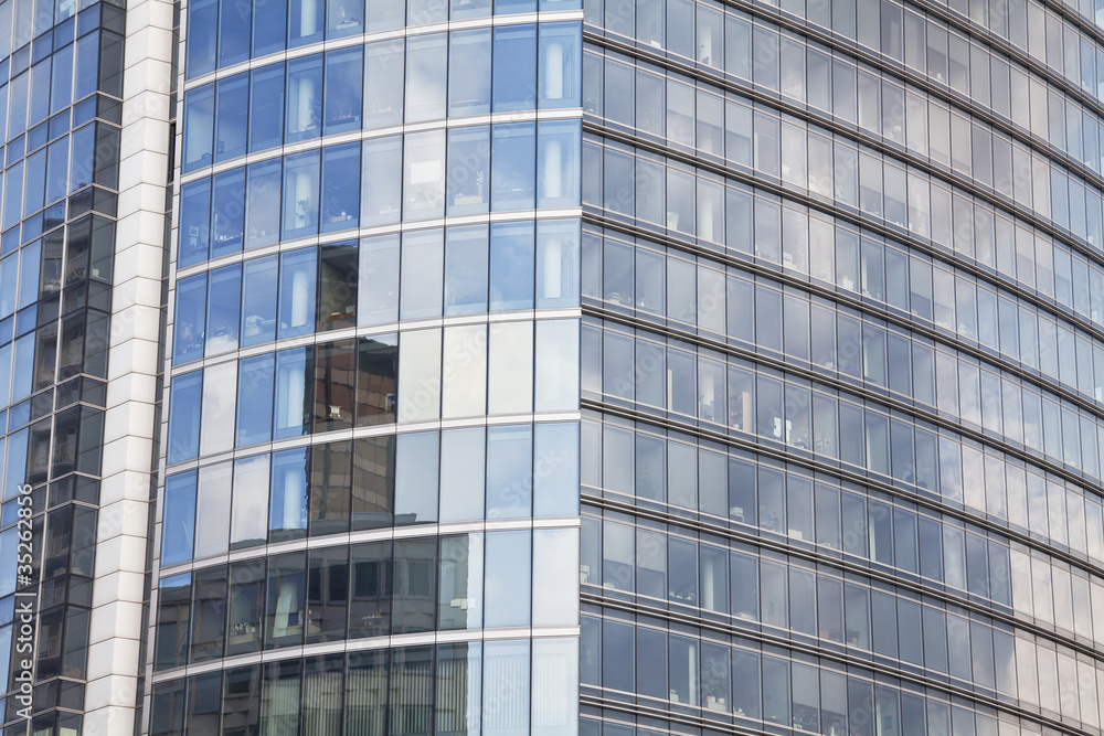 The glass facade office building full of offices.