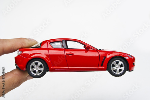 The model of car toy in fingers