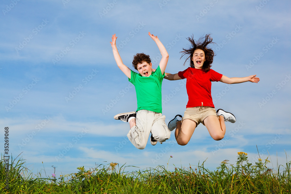 Girl and boy running, jumping outdoor