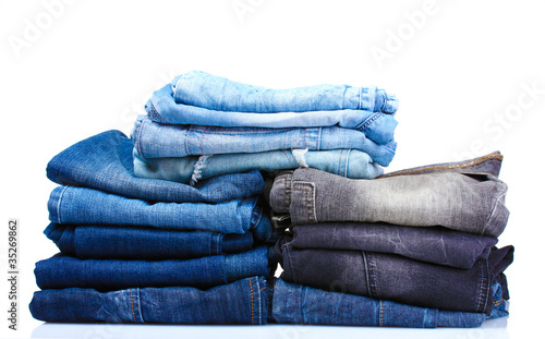 lot of blue jeans isolated on white