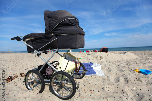 Baby carriage on a sandy beach