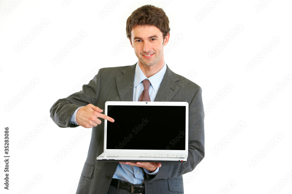 Modern businessman pointing on laptops blank screen Modern businessman pointing on laptops blank screen