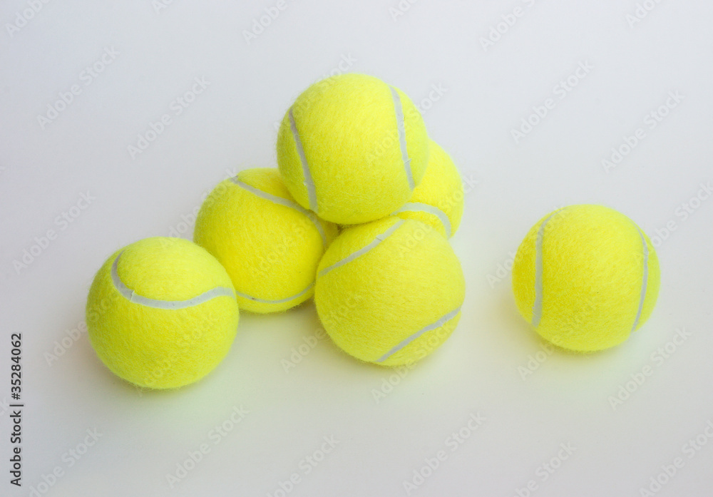 Six yellow tennis ball isolated on gray background