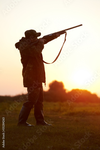 hunter aiming with rifle gun