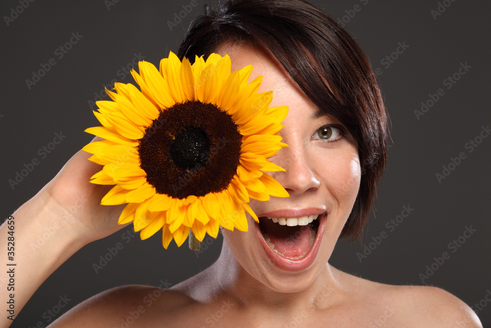 Beautiful happy young girl sunflower to her face Beautiful happy young girl sunflower to her face